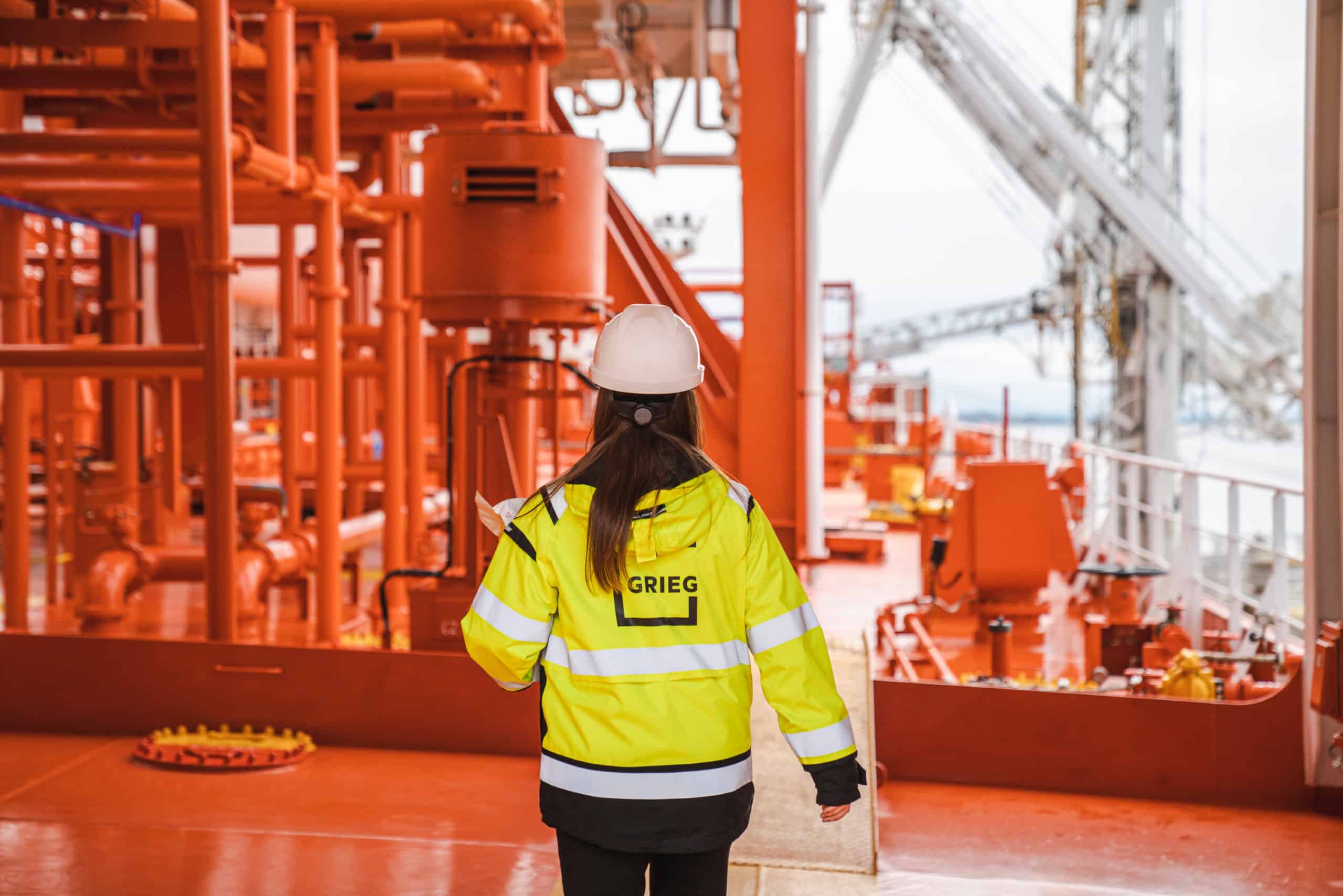 Grieg Logistics employee walking on the deck of a ship
